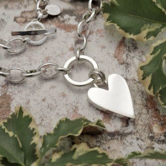 Chunky 1.7mm wide smooth solid silver heart suspended from a 15mm silver circle by a double jump ring on a large loose linked belcher chain necklace