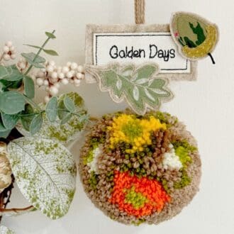 Handmade autumn wool pom pom hanging decoration with acorn and oak leaf applique detail, perfect Autumn home decor
