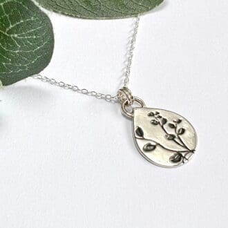 Handmade silver teardrop shape necklace with botanical pattern