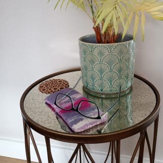 A felted glasses case is shown in situ. The colours range from ivory, lilacs and hot pink.