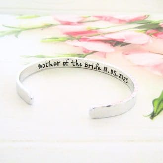 a hammered texture 6mm aluminium cuff bracelet with the words Mother of the Bride or Groom hand-stamped inside along with the date of the wedding
