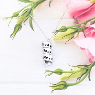 personalised handstamped aluminium hidden message on a spiral bead hung on a silver ball-chain
