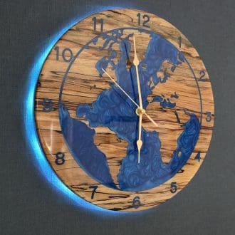 Spalted beech world map wall clock with deep blue resin oceans and integrated LED halo backlight, 315mm handmade wooden clock by The Humble Woodshed.