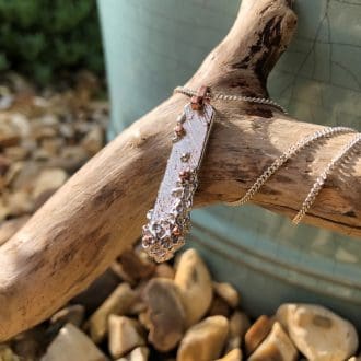 Bespoke recycled silver pendant necklace with barnacle texture and copper accents, made in Cornwall
