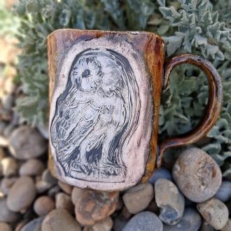 Large coffee mug with dark brown glaze and owl design