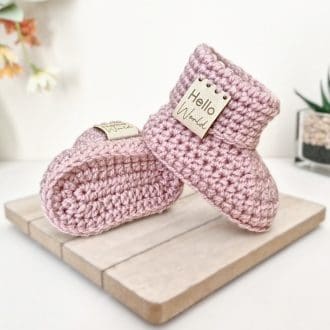 hello World Crochet Baby Booties with Folded Cuff and leather tag saying 'Hello world', pictured in wild Orchid